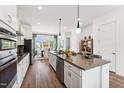 Bright kitchen featuring stainless steel appliances, a large island, and a dining area nearby at 2812 Kempthorne Rd # 59, Cary, NC 27519