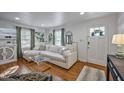 Comfortable living room featuring a large sectional sofa, hardwood floors, and stylish decor at 2836 Oberlin Rd, Raleigh, NC 27608