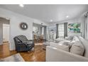 Bright and airy living room with hardwood floors, neutral decor, and a view into the dining area at 2836 Oberlin Rd, Raleigh, NC 27608