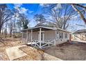 A home with a covered front porch, sidewalk, and grassy yard with mature trees at 2867, 2851 Nc-210 & Galilee Hwy, Smithfield, NC 27577