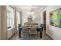 Charming dining room with coffered ceilings, stylish chandelier, and large window providing ample natural light at 314 Umstead St, Sanford, NC 27330