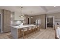 Modern kitchen featuring stainless steel appliances, a large center island with seating, and custom cabinets at 4308 Windsor Pl, Raleigh, NC 27609