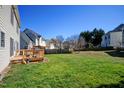 Spacious backyard featuring a well-maintained lawn and a wooden deck, perfect for outdoor entertaining at 5008 Casland Dr, Raleigh, NC 27604