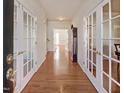 Inviting foyer with gleaming hardwood floors and elegant French doors at 5008 Casland Dr, Raleigh, NC 27604