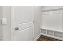 Convenient mud room featuring built-in bench, cubbies, and coat hooks near the home entrance at 504 Lemon Daisy Ln, Knightdale, NC 27545