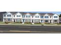 Charming row of new townhomes with manicured lawns and neutral exteriors at 515 Old Battle Bridge Rd, Wendell, NC 27591