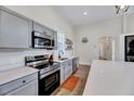 Well-equipped kitchen with stainless steel appliances, gray cabinets, and ample counter space at 57 Lowell Ct, Smithfield, NC 27577