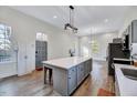 Open kitchen layout with an island, sleek countertops and a modern lighting fixture at 57 Lowell Ct, Smithfield, NC 27577