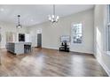 Open concept living room boasts hardwood floors, large windows, and contemporary lighting at 57 Lowell Ct, Smithfield, NC 27577