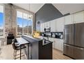 Modern kitchen with white cabinets, stainless steel appliances, breakfast bar, and natural light at 614 Capital Blvd # 229, Raleigh, NC 27603