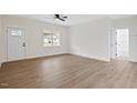 Bright living area with a large window and sleek floors, leading to a bathroom at 704 East St, Smithfield, NC 27577