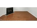 This living room includes a fireplace and hardwood floors at 10805 Cheery Knl, Raleigh, NC 27614