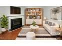 This staged living room features a fireplace and a bookshelf at 10805 Cheery Knl, Raleigh, NC 27614