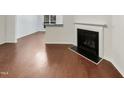 Hardwood floors and fireplace in this cozy living room at 10805 Cheery Knl, Raleigh, NC 27614