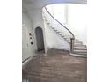 Elegant curved staircase with wooden banister and natural light at 1101 Sunset Ave, Rocky Mount, NC 27804