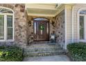 Beautiful stone entrance and front door with sidelights create a welcoming feeling at 116 Old Pros Way, Cary, NC 27513