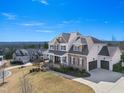 Stately two-story home features a manicured lawn, mature trees, and a side-entry two car garage at 158 Futrell Ridge Ct, Chapel Hill, NC 27517