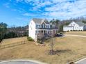 Traditional-style two-story home with manicured lawn, wrought iron fence, and mature trees at 158 Futrell Ridge Ct, Chapel Hill, NC 27517
