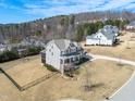 Traditional-style two-story home with manicured lawn, wrought iron fence, and mature trees at 158 Futrell Ridge Ct, Chapel Hill, NC 27517