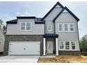 New two-story home showcasing a modern design with gray siding and a two car garage at 167 S Harvest Ridge Way # Homesite 223, Wilson's Mills, NC 27520