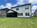 Expansive backyard featuring a screened porch, lush lawn, and plenty of space for outdoor activities at 167 S Harvest Ridge Way # Homesite 223, Wilson's Mills, NC 27520
