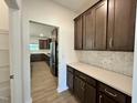 A view of the kitchen featuring ample counter space, stainless appliances, and brown cabinets at 167 S Harvest Ridge Way # Homesite 223, Wilson's Mills, NC 27520