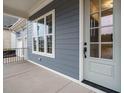 Charming covered porch showcasing gray siding, white trim, and a stylish front door at 213 Big Bradley Dr, Wendell, NC 27591
