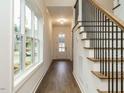 Inviting foyer with hardwood floors, a staircase, and a view of the front door at 213 Big Bradley Dr, Wendell, NC 27591