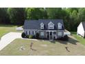 Beautiful two-story home featuring dormer windows and a well-manicured lawn with mature trees at 2570 Sweet Bay Rd, Rocky Mount, NC 27804