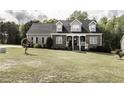 Inviting two-story home with manicured lawn and lush greenery, featuring dormer windows at 2570 Sweet Bay Rd, Rocky Mount, NC 27804