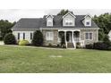 Charming two-story home with stone accents and a welcoming front porch, beautifully landscaped at 2570 Sweet Bay Rd, Rocky Mount, NC 27804