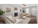 Bright living room featuring a fireplace, ceiling fan, and modern furniture at 286 Audrey Cir, Garner, NC 27529
