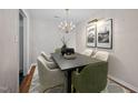 Formal dining room with stylish lighting, seating for six, and elegant decor at 3027 Maple Ave # D2, Burlington, NC 27215
