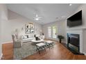 Bright living room featuring hardwood floors, fireplace, and access to the backyard at 3027 Maple Ave # D2, Burlington, NC 27215