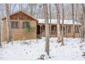 Brick home with a covered porch, nestled among snow-covered trees at 3412 Hackney Ct, Raleigh, NC 27613