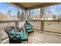 Cozy balcony with two wicker chairs and green cushions, perfect for outdoor relaxation at 401 Oak Hollow Ct, Raleigh, NC 27613