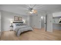 Bright main bedroom with light hardwood floors, ceiling fan and ensuite bath at 401 Oak Hollow Ct, Raleigh, NC 27613