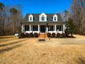 Charming two-story home featuring a wide front porch with columns and a basketball hoop at 42 Miry Branch Ct, Garner, NC 27529