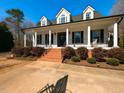 Charming home featuring a welcoming front porch with classic white columns and a landscaped garden at 42 Miry Branch Ct, Garner, NC 27529