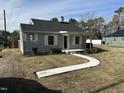 This home has light gray siding, a dark roof, and a covered front porch at 4319 Denfield St, Durham, NC 27704