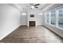 Bright living room with a fireplace, ceiling fan, and large windows offering plenty of natural light at 475 Bramble Ln, Clayton, NC 27527