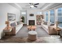 Bright, modern living room featuring hardwood floors, a fireplace, and a neutral color palette at 475 Bramble Ln, Clayton, NC 27527