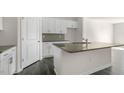 Modern kitchen featuring white cabinets, stainless steel appliances, granite countertops, and dark wood flooring at 519 Old Battle Bridge Rd, Wendell, NC 27591