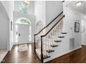 Bright foyer with hardwood floors, grand staircase, and natural light from large windows at 601 Walcott Way, Cary, NC 27519