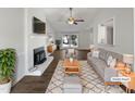 Bright living room featuring a fireplace, large window, and hardwood floors at 7271 Shellburne Dr, Raleigh, NC 27612