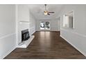 Spacious living room featuring a fireplace, large window, and hardwood floors at 7271 Shellburne Dr, Raleigh, NC 27612