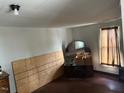 A bedroom featuring a window with curtain, dark wood floors, and built-in vanity at 749 Southerland St, Henderson, NC 27536
