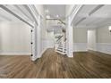 Spacious living room with high ceilings, an open staircase, decorative trim, and hardwood floors adding warmth and character at 1005 Keith Rd, Wake Forest, NC 27587