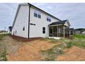 This home features a screened in porch, and a concrete patio in the backyard at 1063 Fairhaven Dr # 54, Mebane, NC 27302