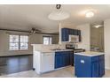 Open kitchen with stainless steel appliances, ample counter space, and views of the dining area at 117 Crabwall Ct, Holly Springs, NC 27540